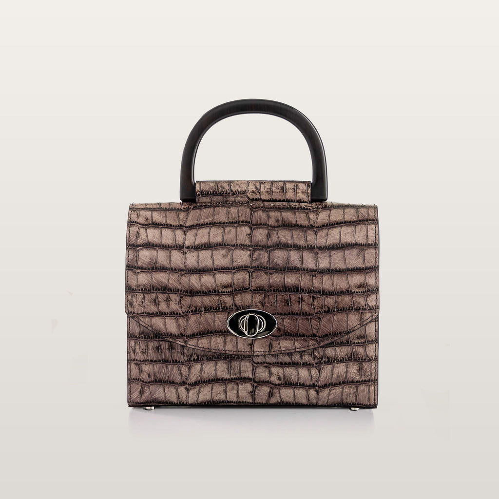 Brown textured handbag with a black handle on a light gray background