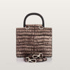 Brown textured handbag with black handle and matching strap on a light gray background