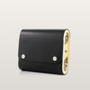 Black handbag with gold accents on a light gray background
