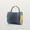 Blue textured handbag with a colorful design 