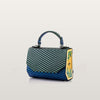 Green and blue patterned handbag with a yellow floral design on a light gray background
