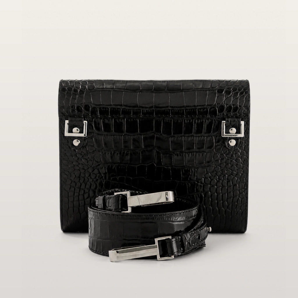 Black crocodile-patterned handbag with matching belt on a light gray background