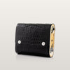 Black crocodile-patterned clutch bag with gold accents on a light gray background