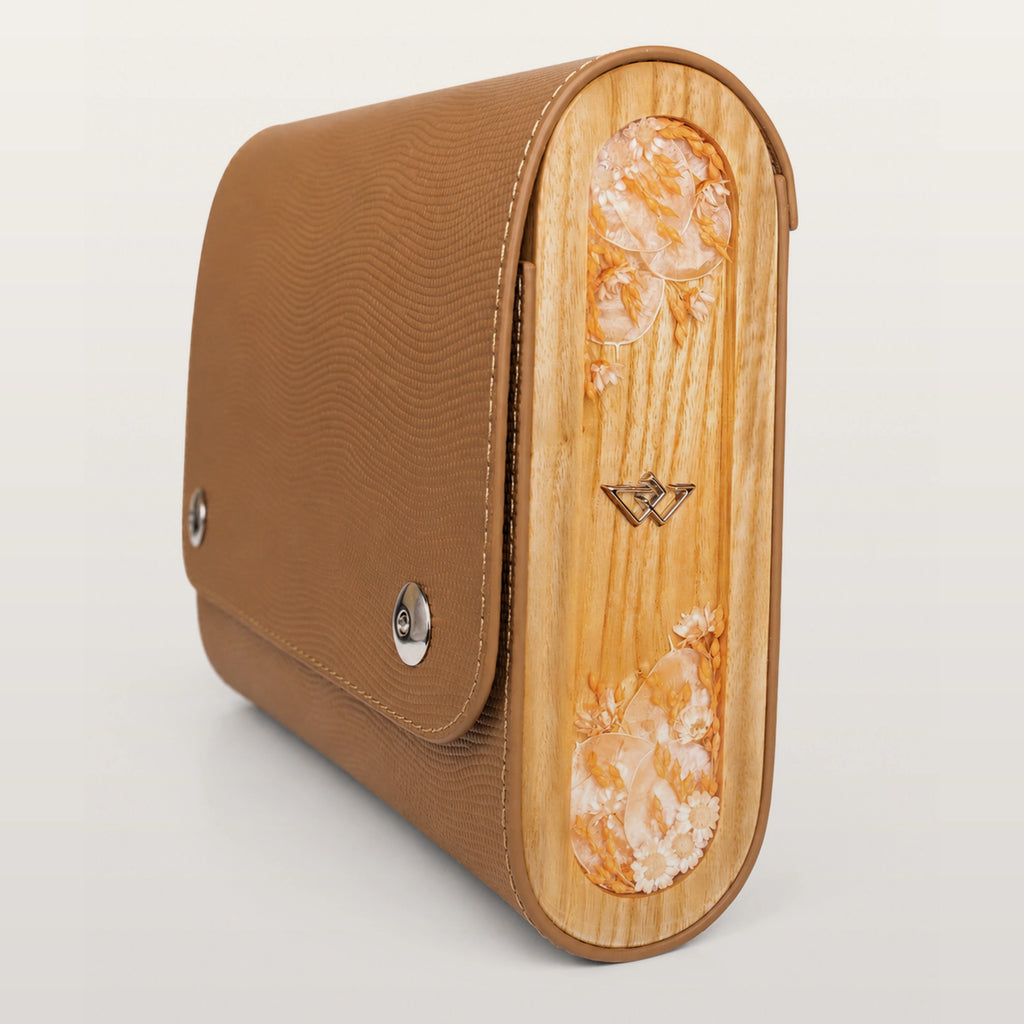 Brown leather clutch with wooden side on a light gray background