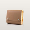 Beige handbag with wooden accents on a light gray background