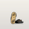 Wooden shoe tree and black leather belt on a light gray background
