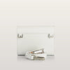 White leather clutch with matching belt on a light gray background