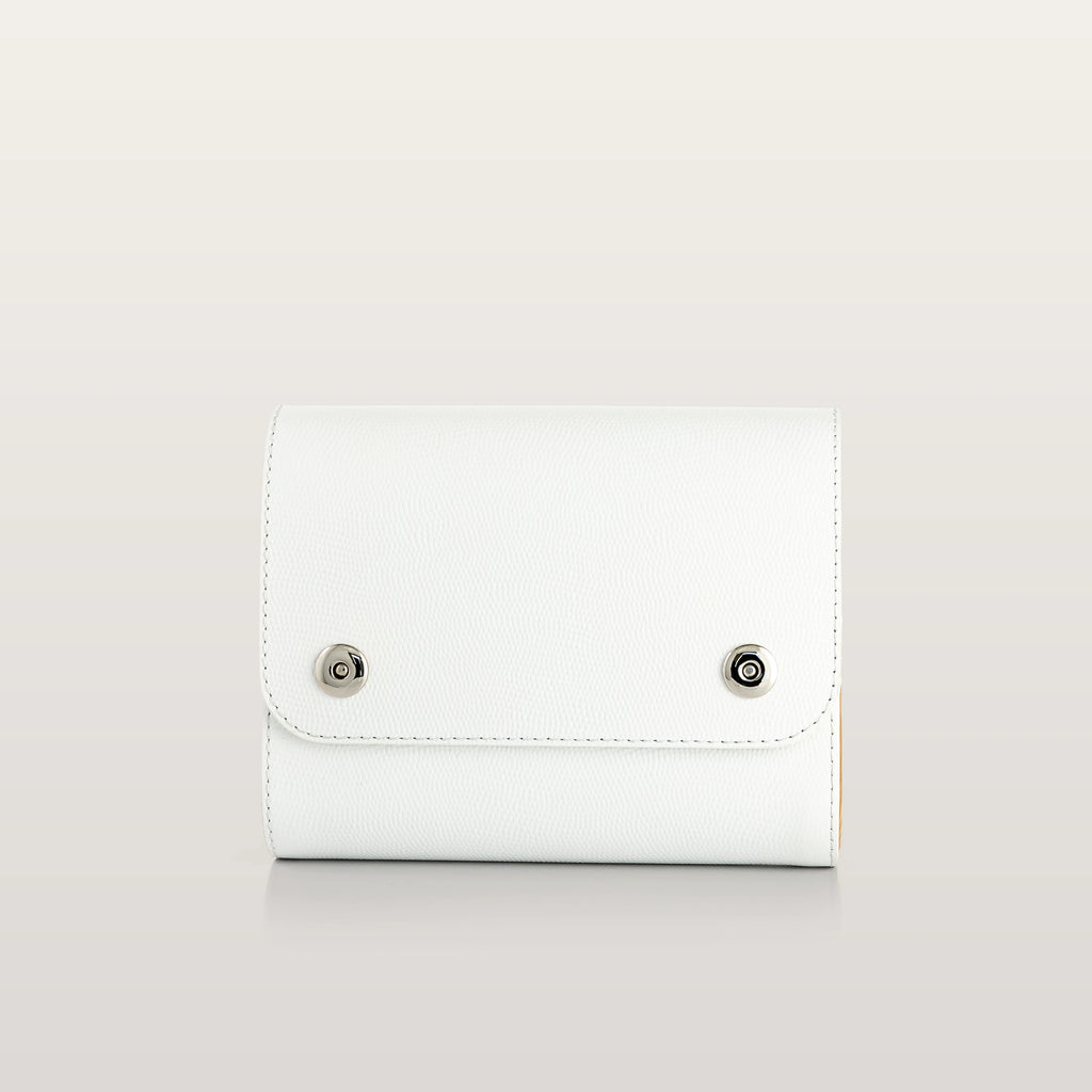 Whiteleather bag with metallic accents on a light gray background