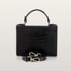 Black crocodile-patterned handbag with a strap on a light gray background