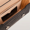 Close-up of a leather wallet with crocodile texture and visible brand logo.