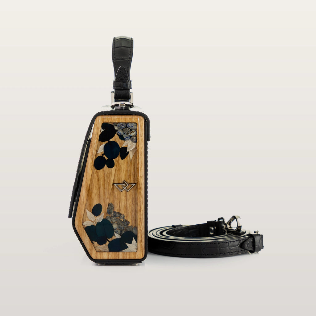 Wooden luggage tag with black strap on a light gray background