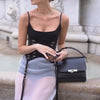 Model wearing handcrafted BLACKWOOD Gloria Black Croco leather handbag, side view